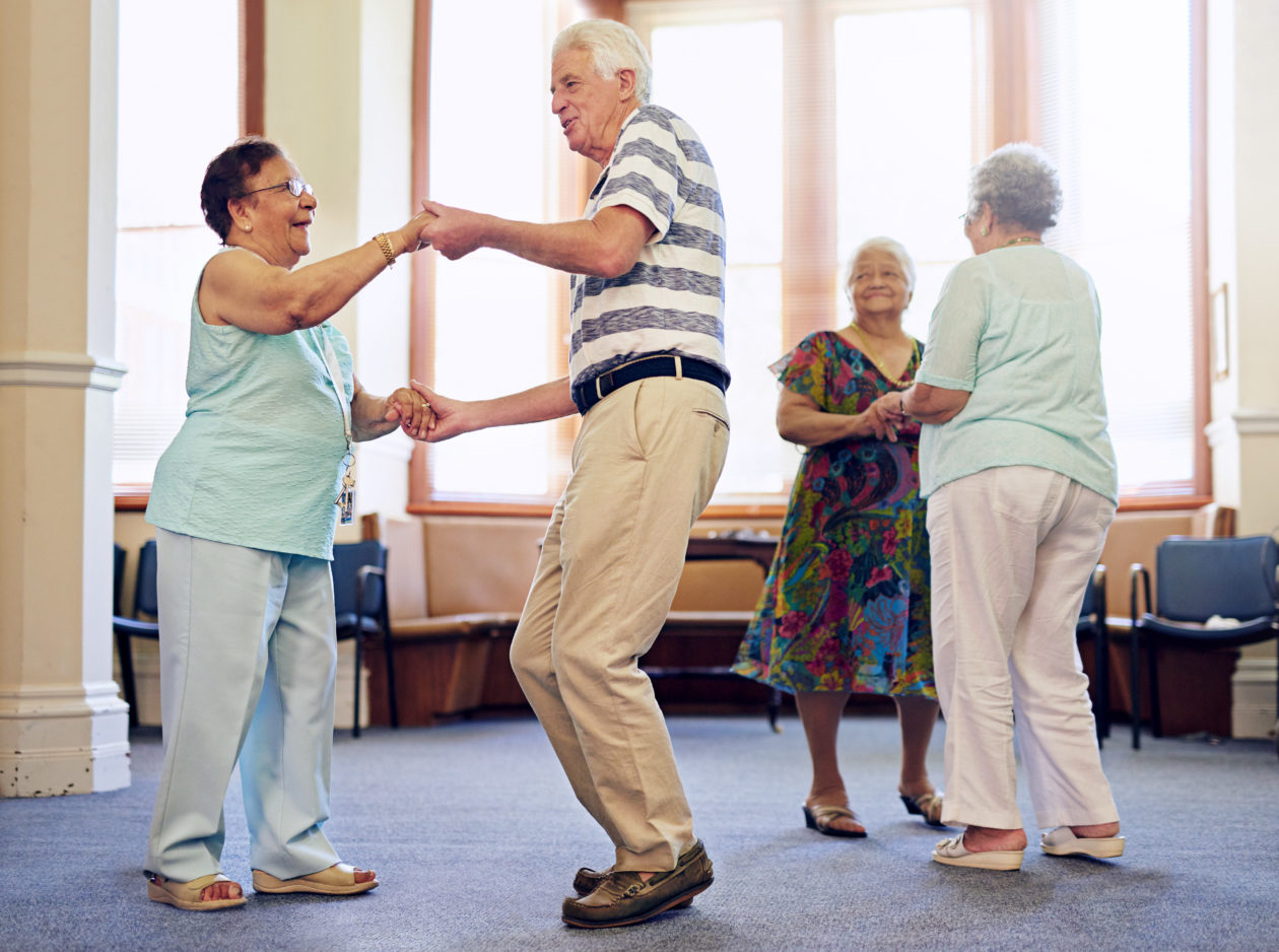 Four aged people dancing