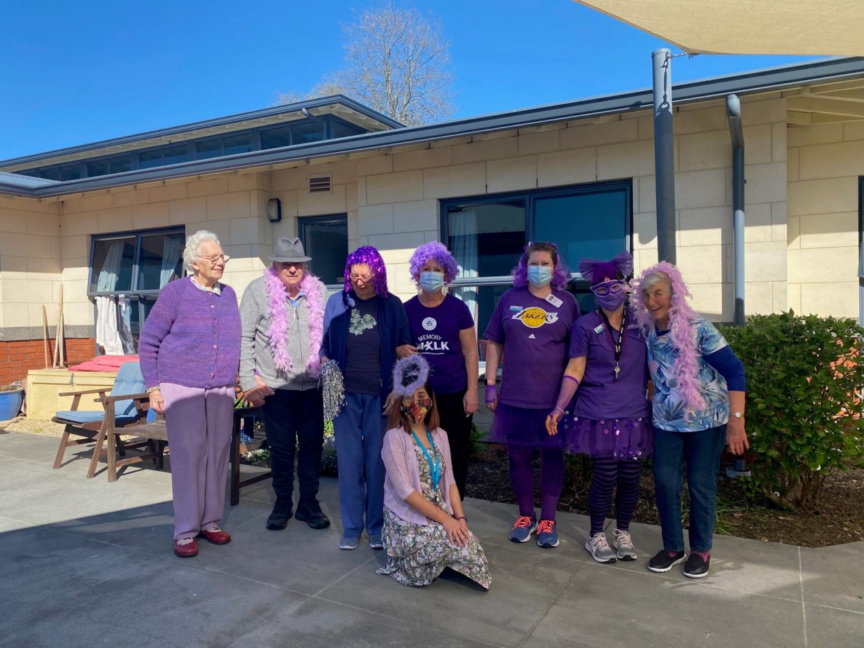 Residents and staff  from the croft rest home grouped together wearing purple 