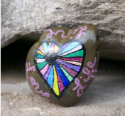 a rock with a colorful heart painted on it