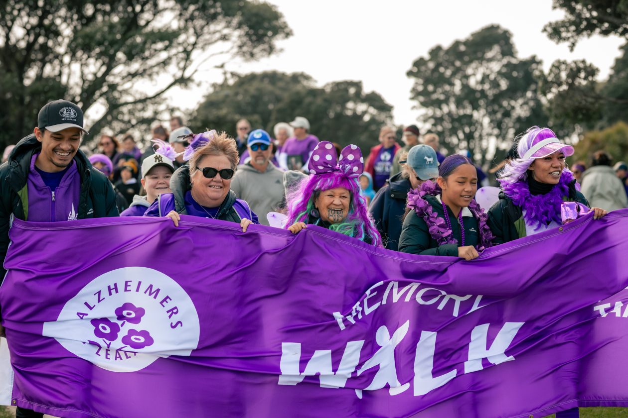 close up of a family and staff carrying the banner