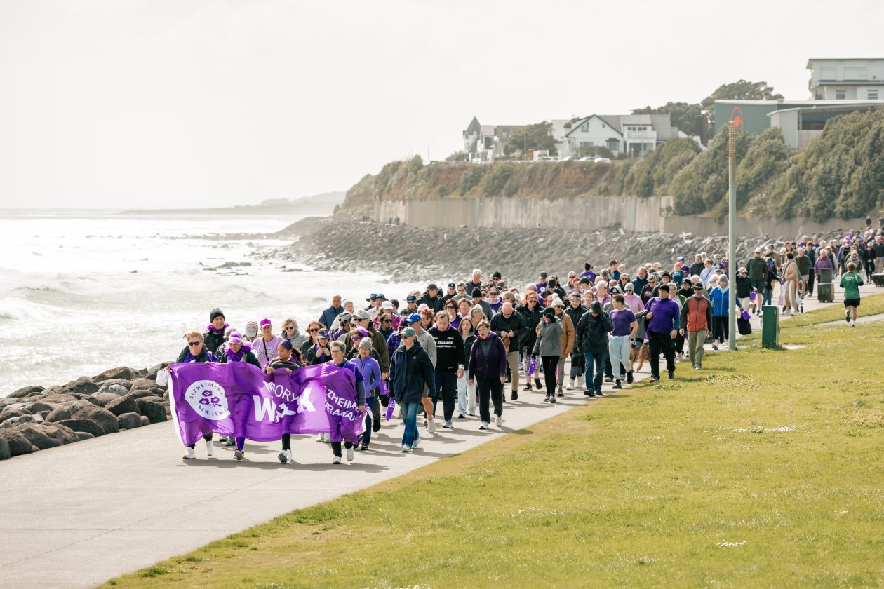 Large group photo of the walkers coming down following the banner