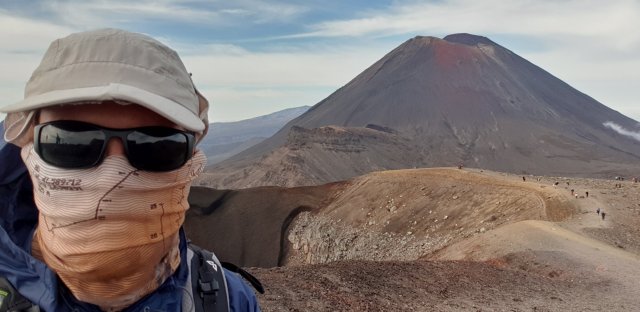 Dean taking a selfie in front of a mountain on his journey