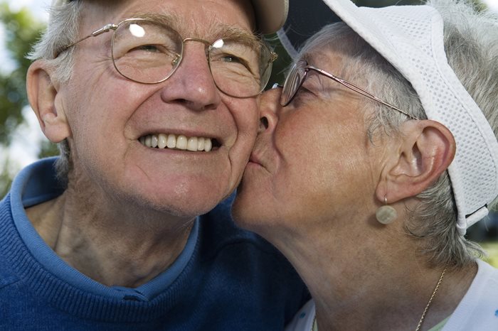 Wife kissing husband on the cheek