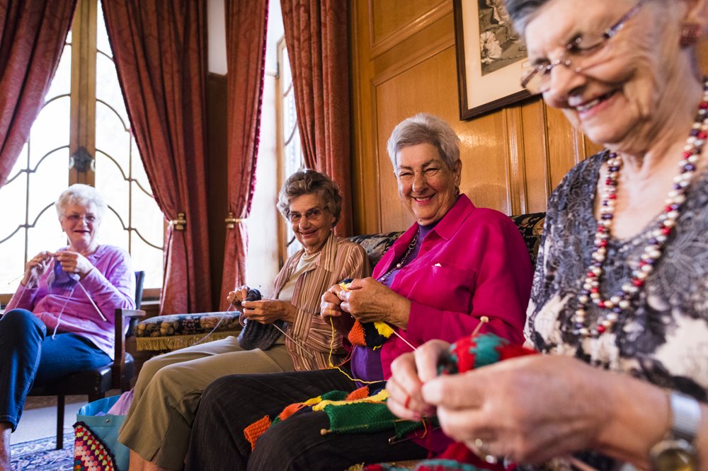 Senior women knitting together