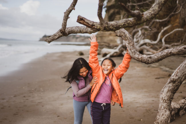 Mother and daughter playing together on a beach