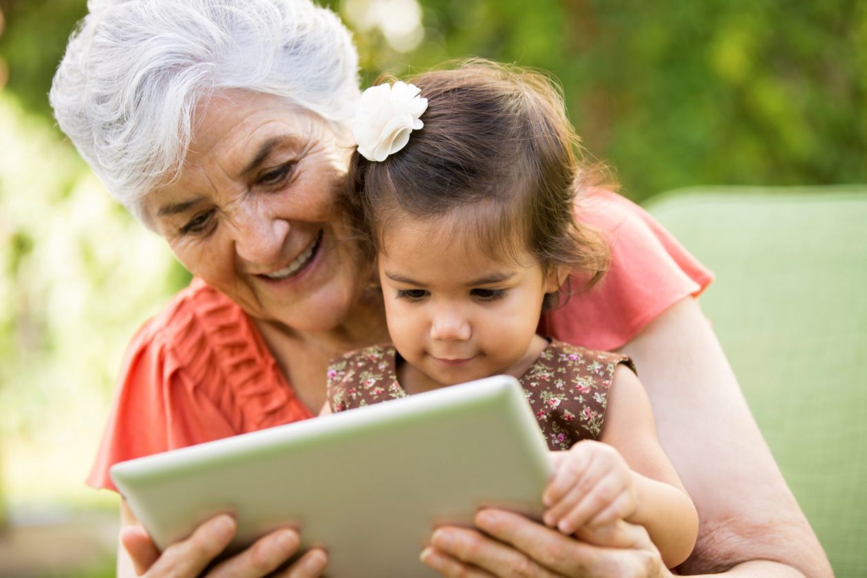 Woman using a tablet with child